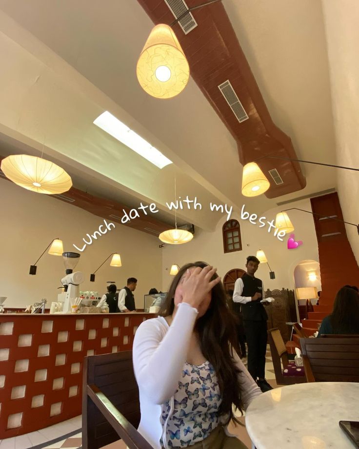 a woman sitting at a table in front of a sign that reads, lunch date with my bestie