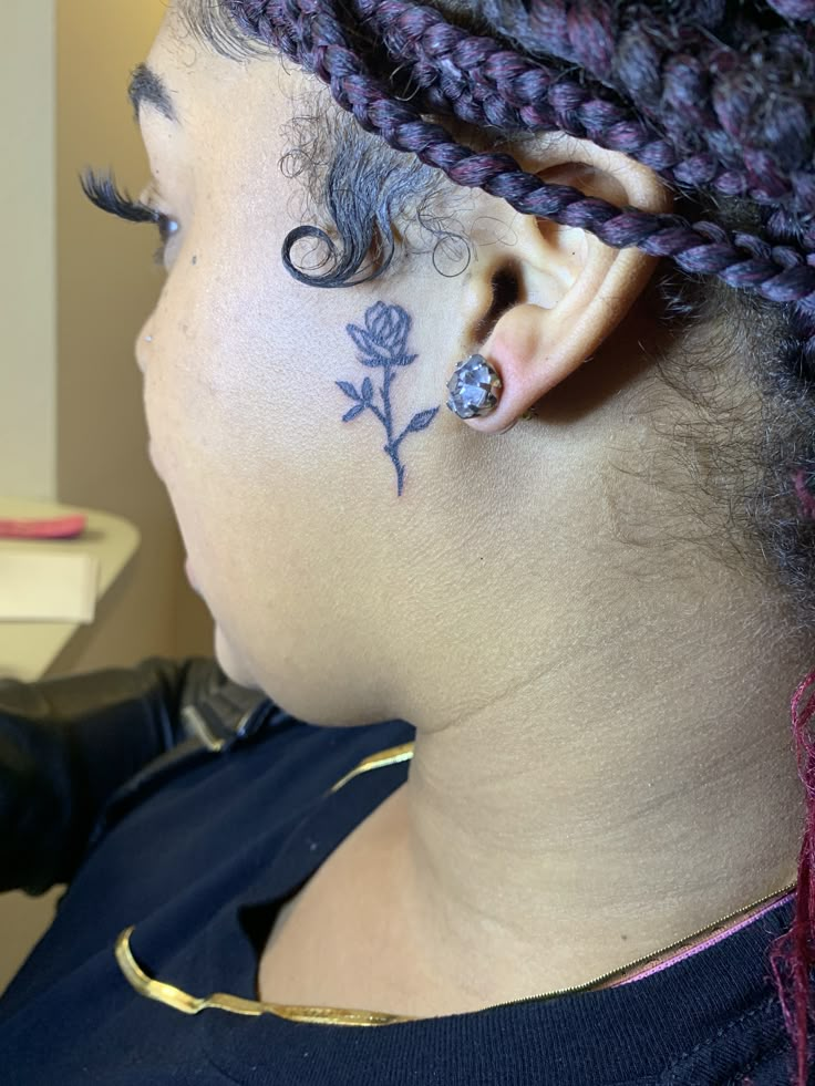 a woman with tattoos on her face and ear