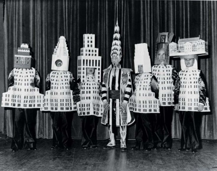 an old black and white photo of people dressed in costumes made out of legos