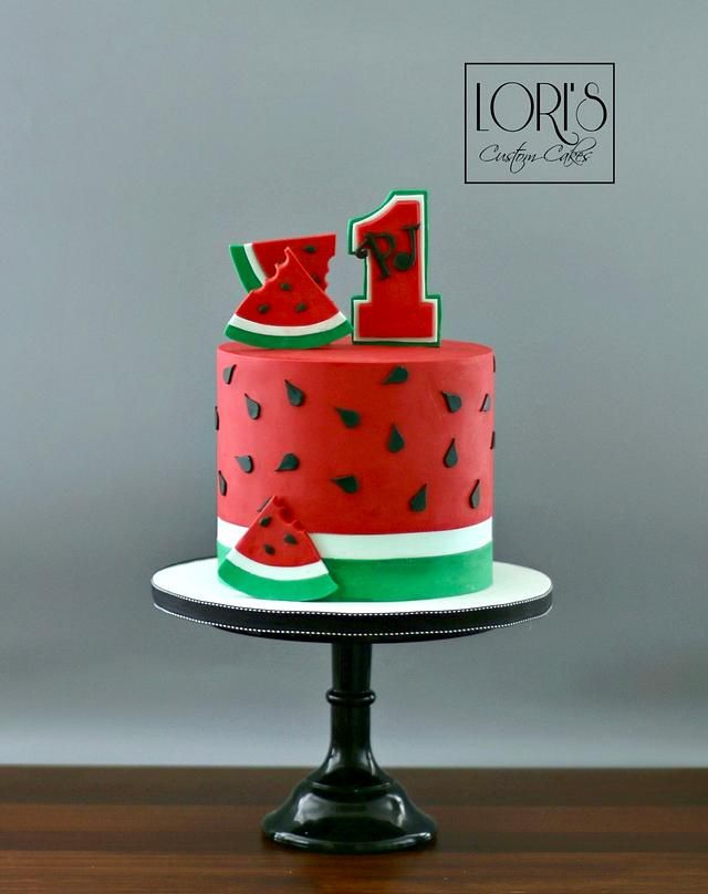 a watermelon cake with the number one on top