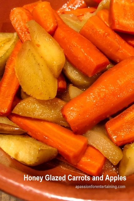 sliced carrots and apples in a bowl on a wooden table with the words honey glazed carrots and apples