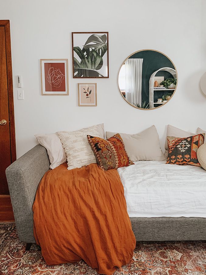 a living room filled with furniture and pictures on the wall