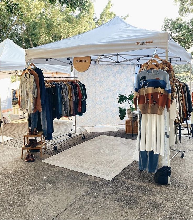 a tent with clothes on display in front of it