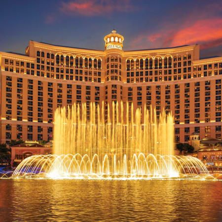 the fountains are lit up in front of the hotel