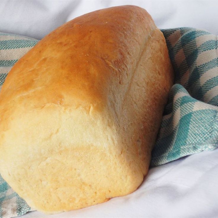 a loaf of bread sitting on top of a blue and white towel