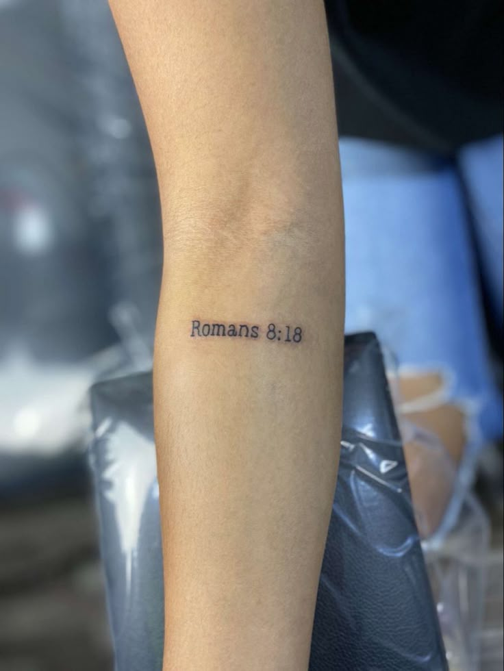 a woman's arm with the word romans on it