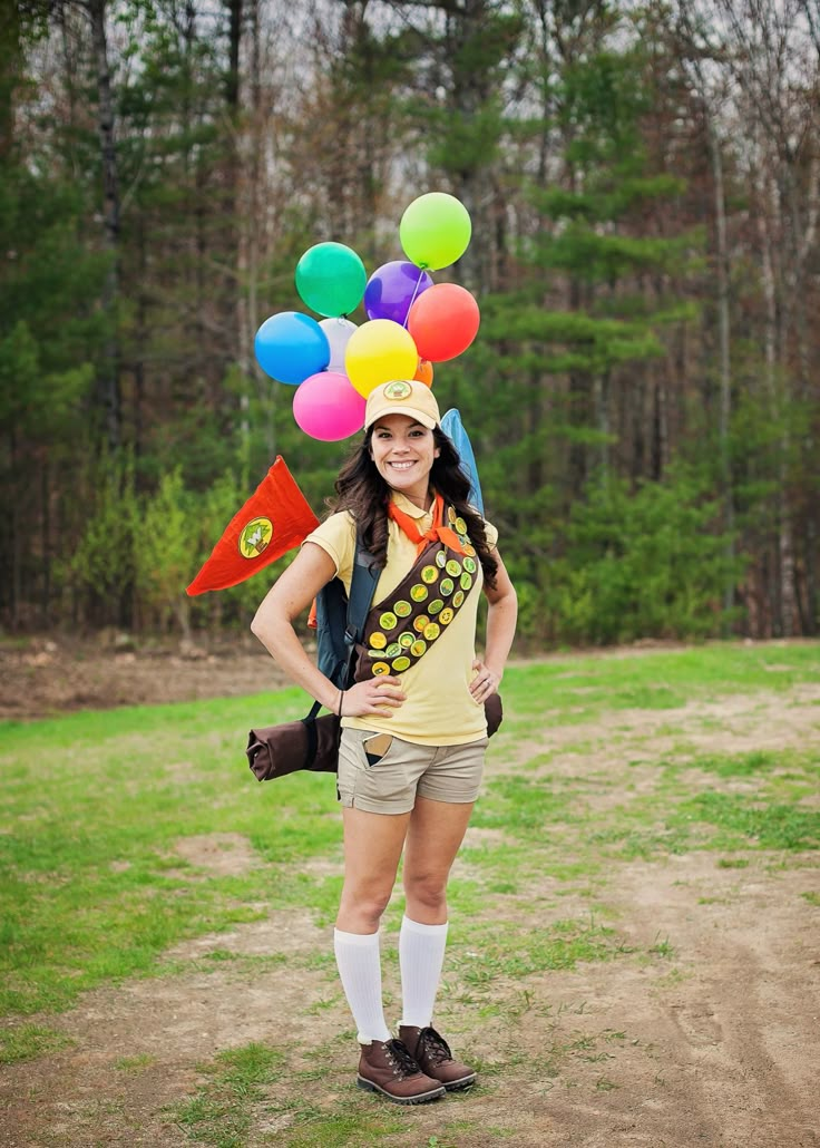 a woman in shorts and a hat with balloons on her head