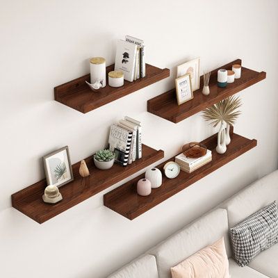 three floating shelves on the wall above a couch