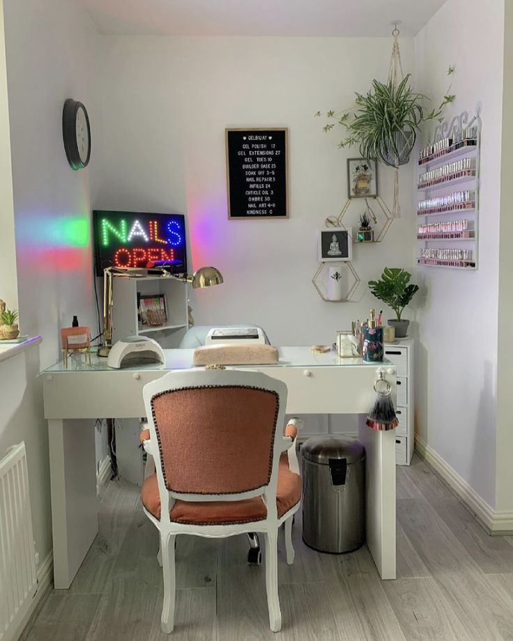 an office with a desk, chair and potted plant on the wall above it