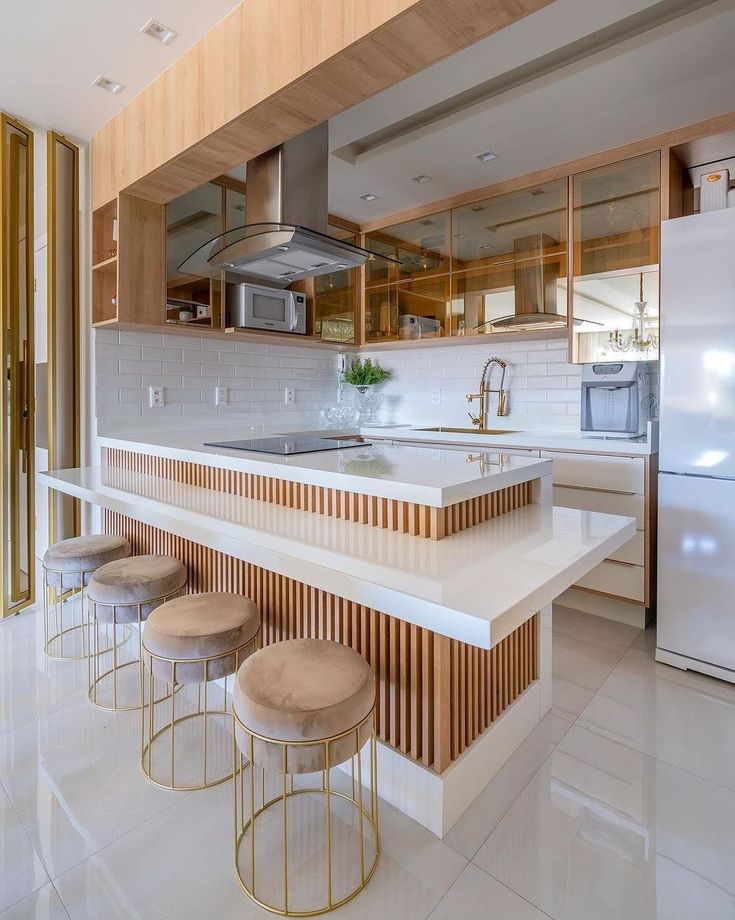 a kitchen with an island and stools in it