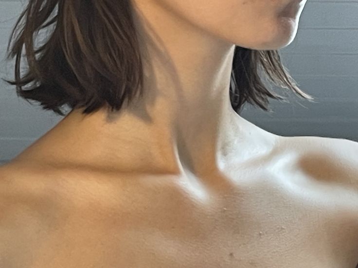 a close up of a woman with no shirt on