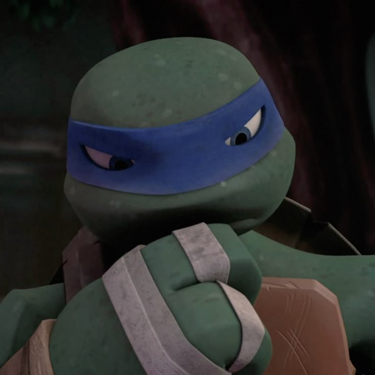 the teenaged ninja turtle is holding his head in one hand and looking at something