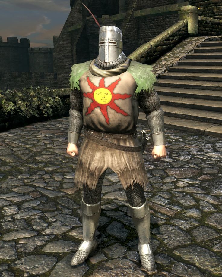 a man dressed in armor standing on cobblestone