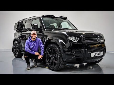 a man kneeling next to a black suv