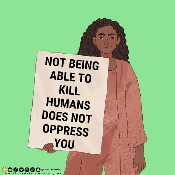 a woman holding a sign that says not being able to kill humans does not oppressed you