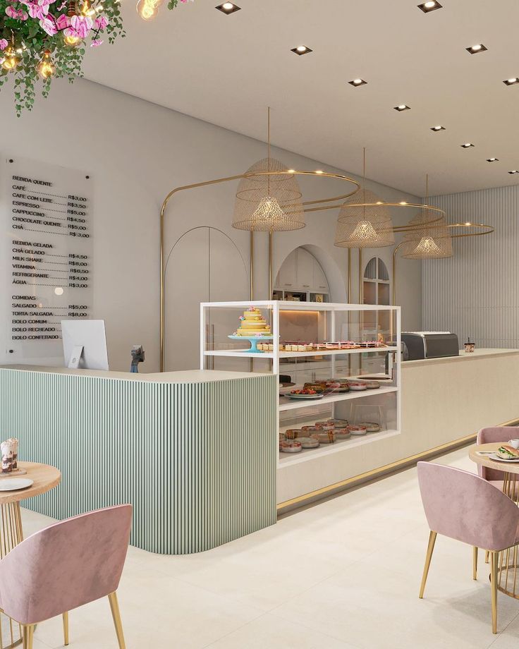 the interior of a bakery with pastel colors and gold trimmings on the walls