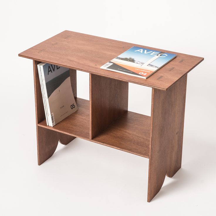 a wooden table with books on it and magazines in the bottom shelf next to it