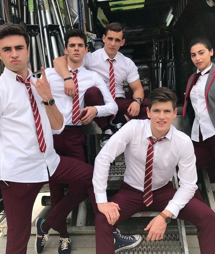 a group of young men wearing red ties posing for a photo in front of a firetruck