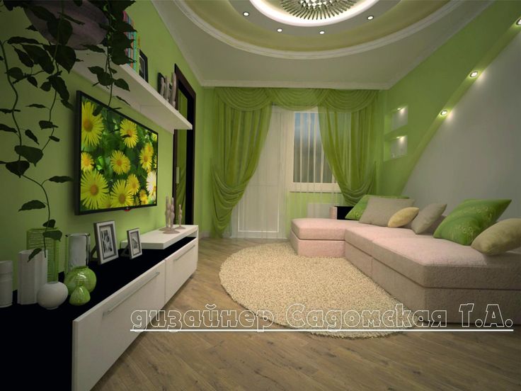 a living room with green walls and white furniture