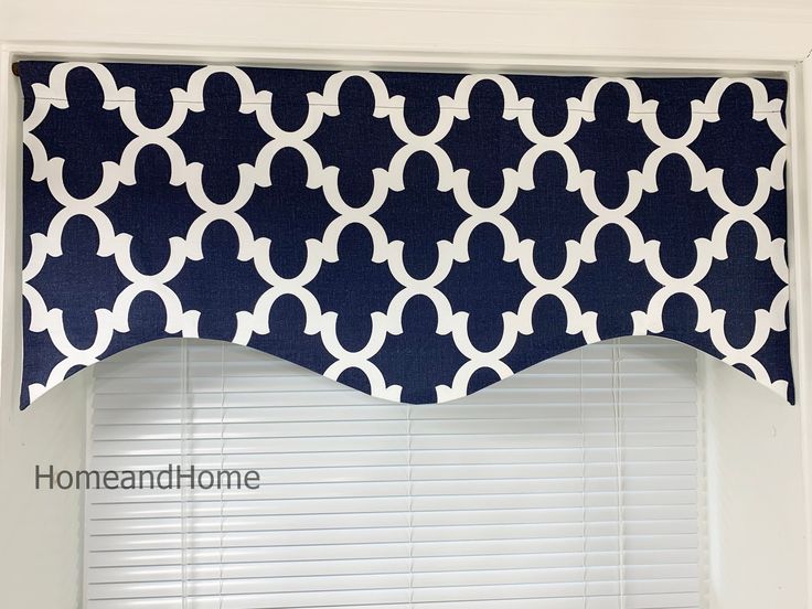 a blue and white window valance hanging over a window