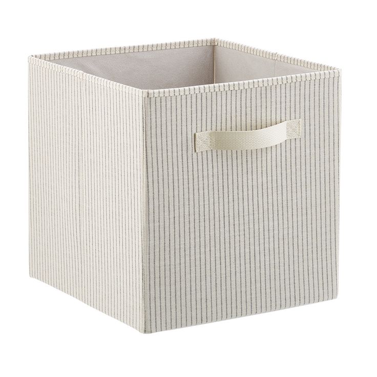 a white striped storage box with a leather handle