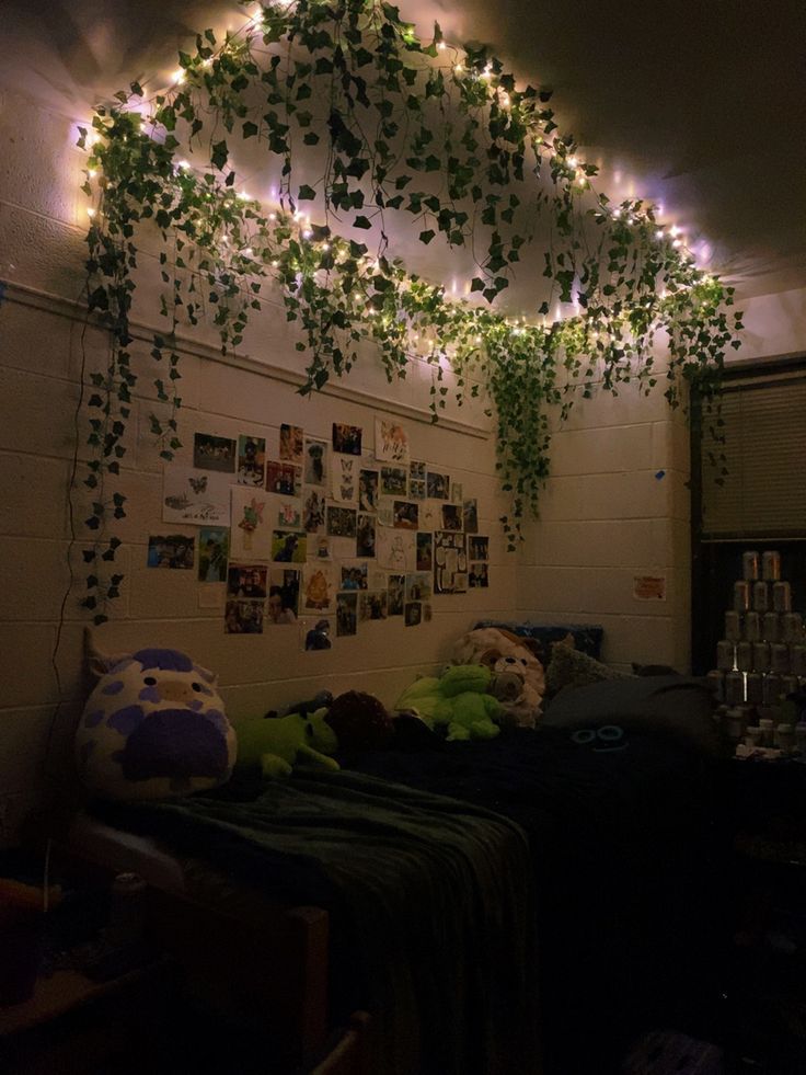 a bedroom with plants growing on the wall and pictures hanging from the ceiling above it