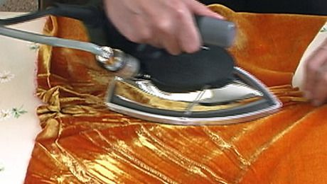 a person ironing fabric with an iron