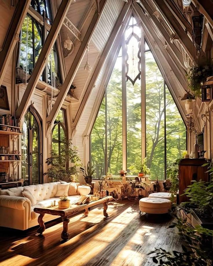 a living room filled with lots of furniture next to tall windows and plants on the floor