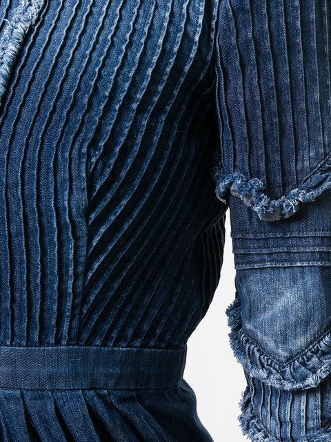 the back of a woman's blue dress with ruffles and pleating