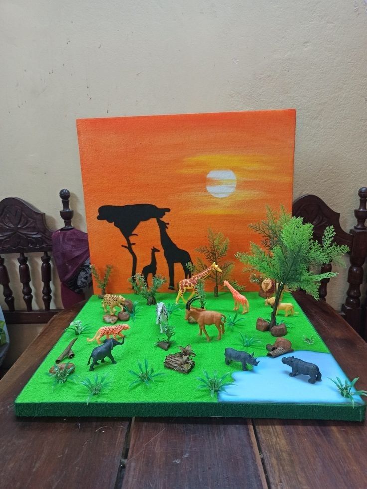 a table topped with fake animals and trees