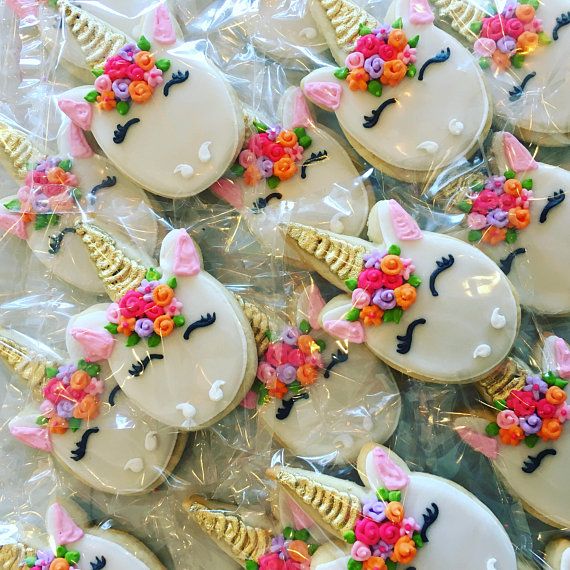 many decorated cookies in the shape of unicorns