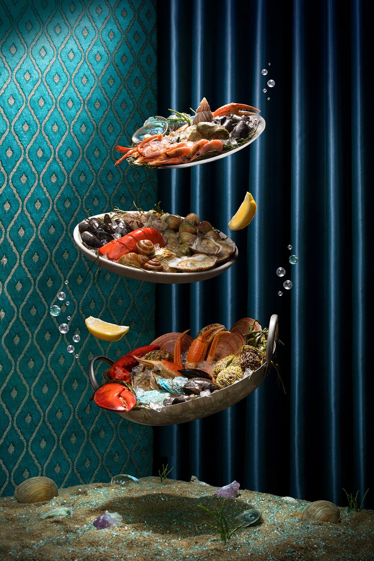 three tiered trays filled with food floating in the air