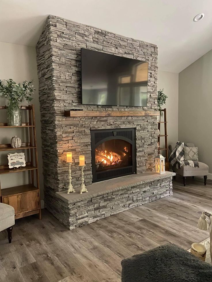 a living room with a fire place and a flat screen tv mounted on the wall