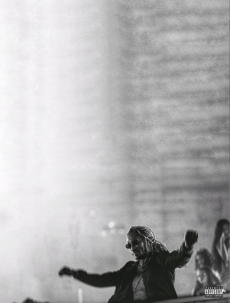 a man standing on top of a stage with his arms out in front of him