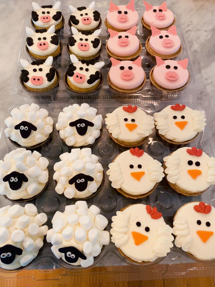 there are many cupcakes with farm animals on them