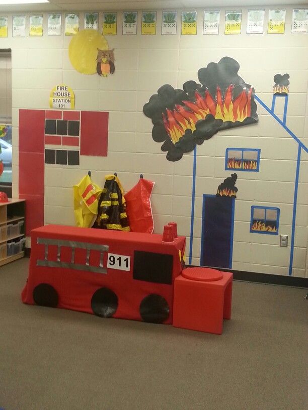 a firetruck themed classroom with toys and decorations on the wall in front of it