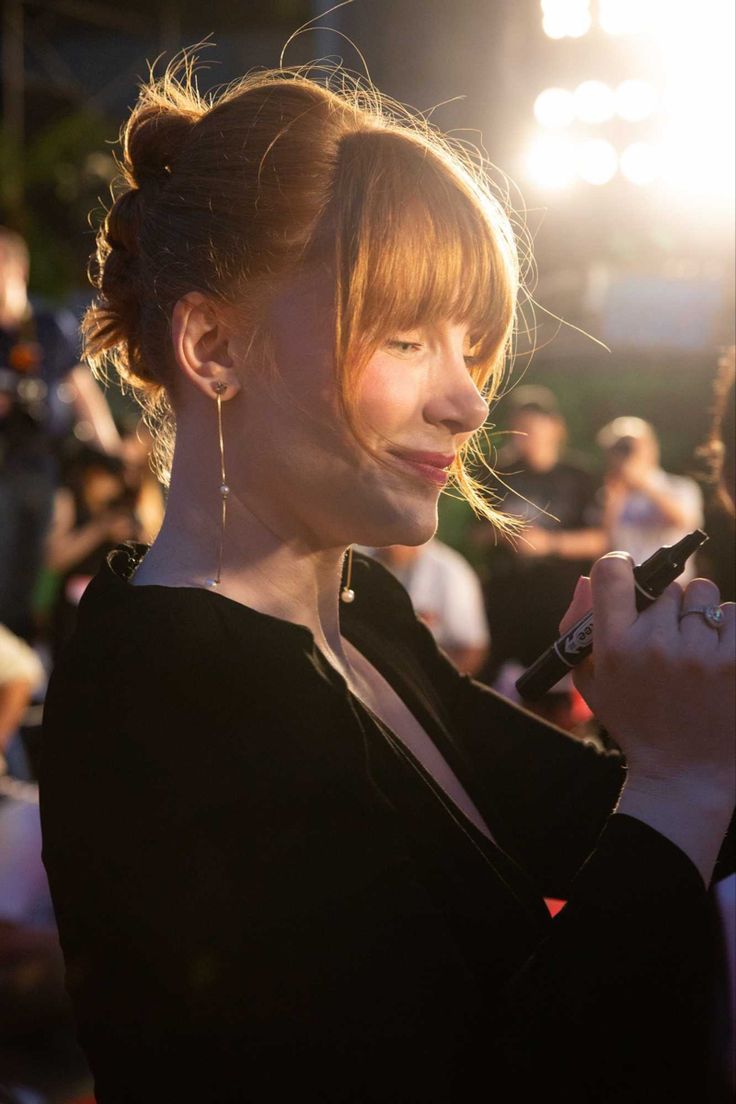 a woman is getting her hair done at an event