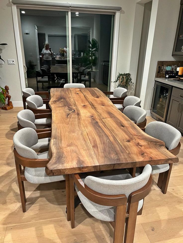 a large wooden table surrounded by white chairs