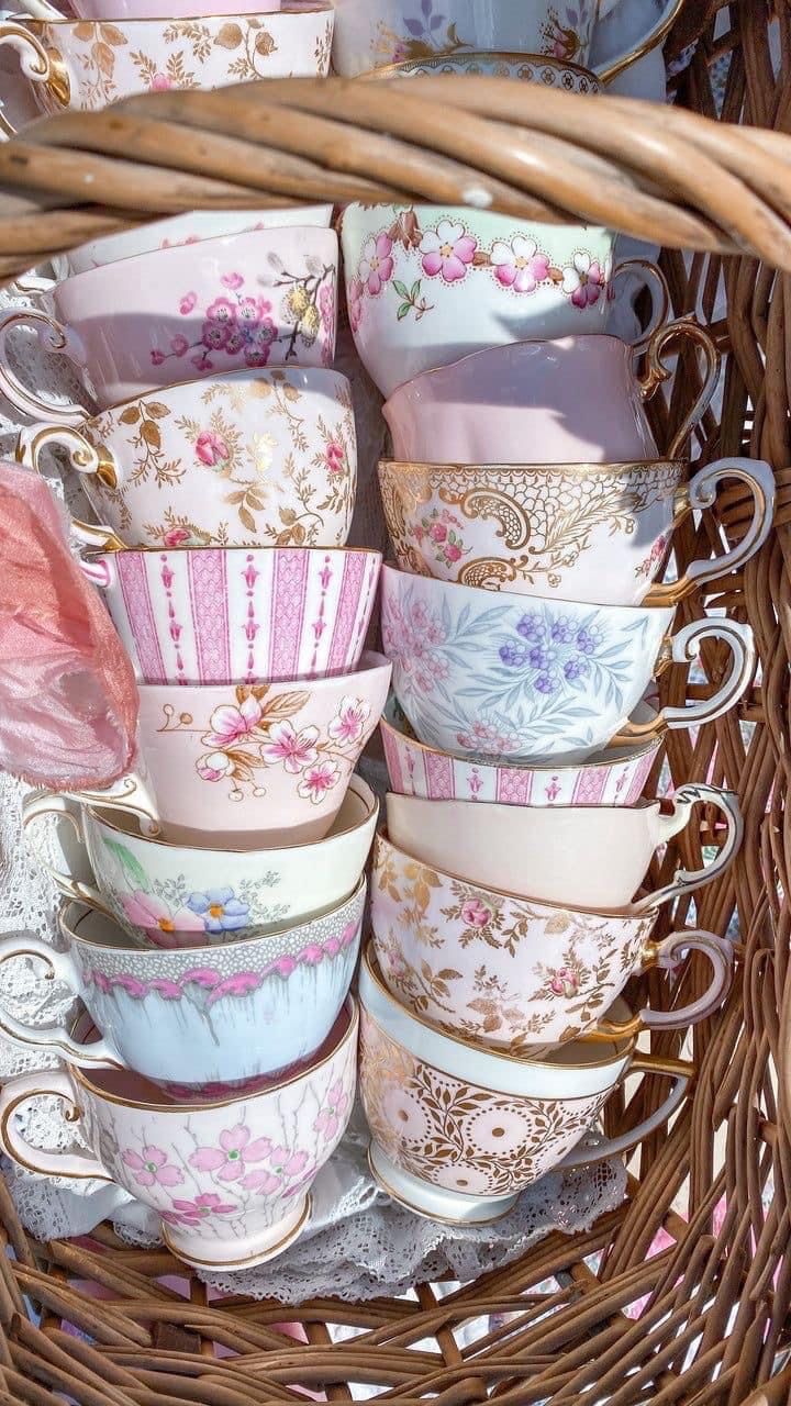 a basket filled with lots of cups and saucers