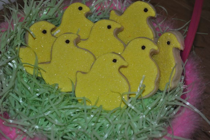 decorated cookies in the shape of ducks sitting on grass