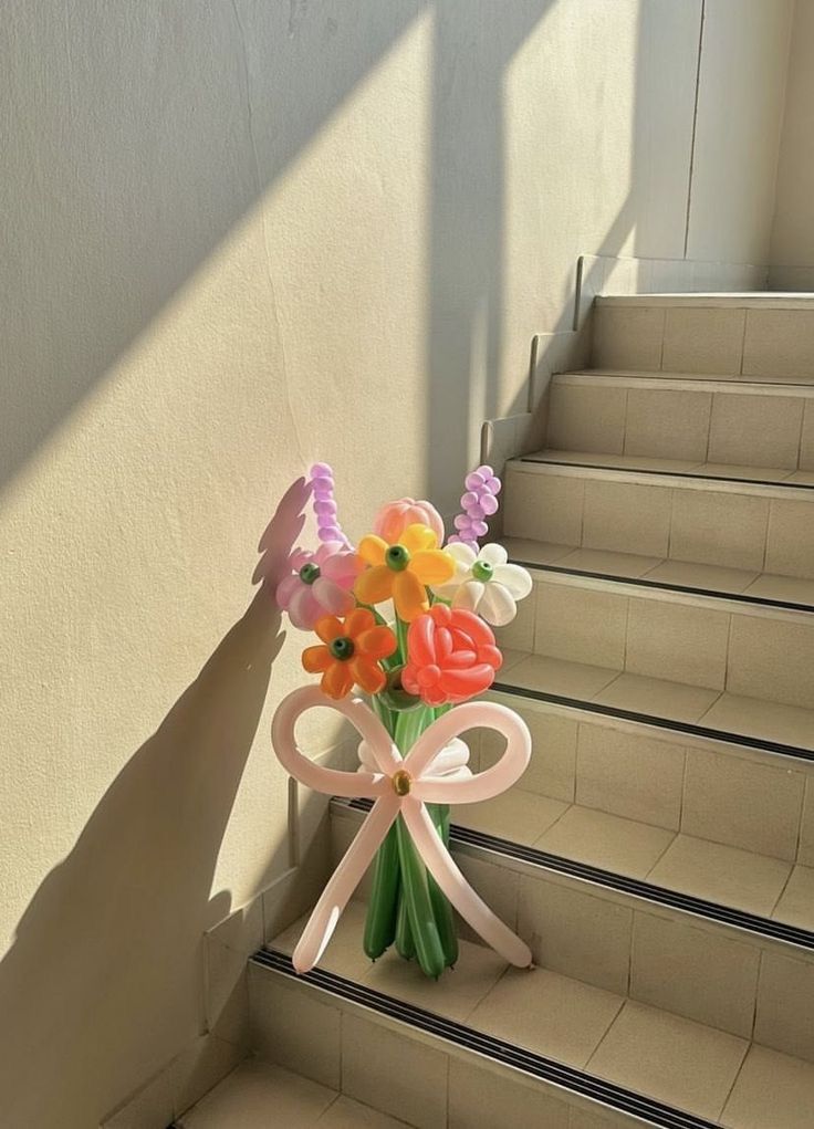 a bouquet of flowers sitting on top of a set of stairs