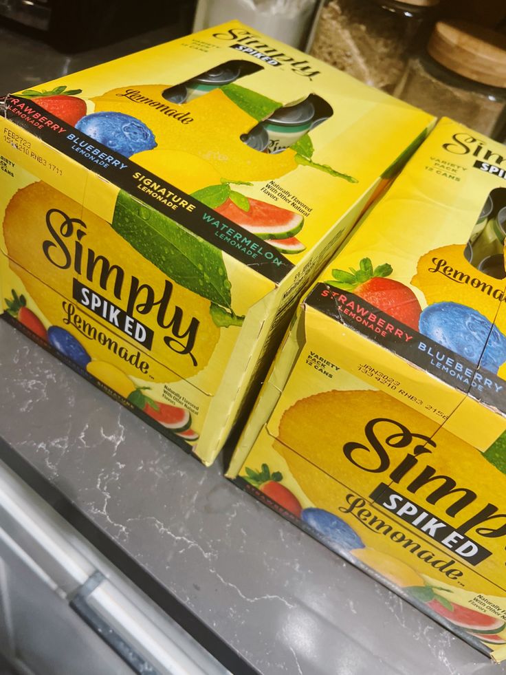 three boxes of simply sparkling lemonade sitting on top of a counter in a store