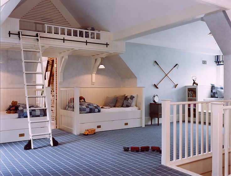 there is a loft bed with stairs to the second floor and another room in the background