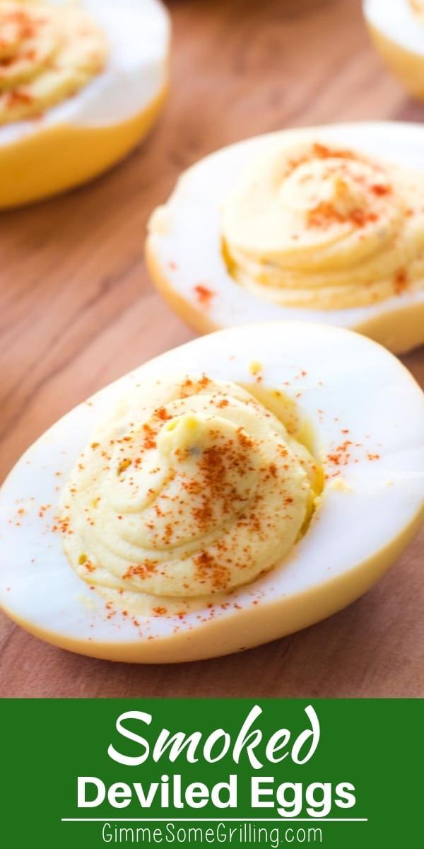 deviled eggs with cinnamon sprinkles are on a cutting board and there is text overlay that says smoked deviled eggs