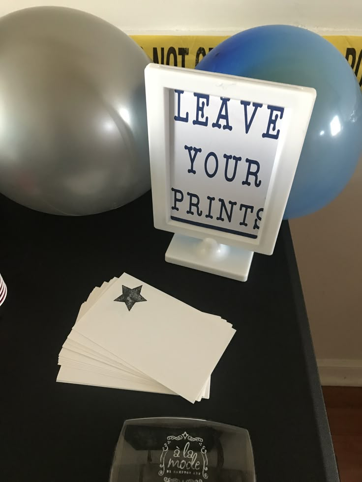 a table with balloons and signs on it that read leave your print, not star