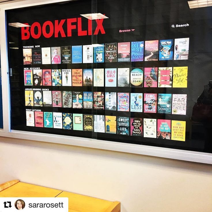 there is a large poster on the wall with books written in red and black letters