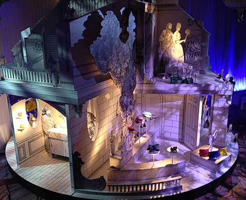 an elaborately decorated stage set for a play in the middle of a room with blue curtains