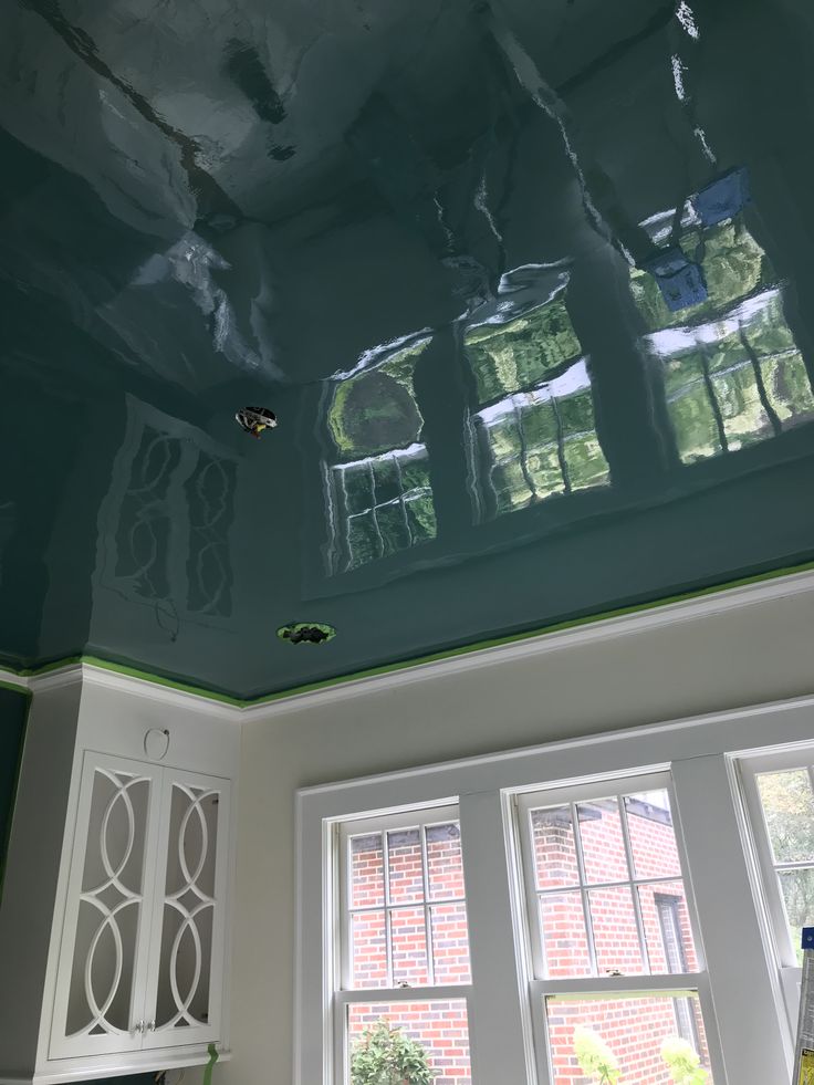 the ceiling is being painted green and white