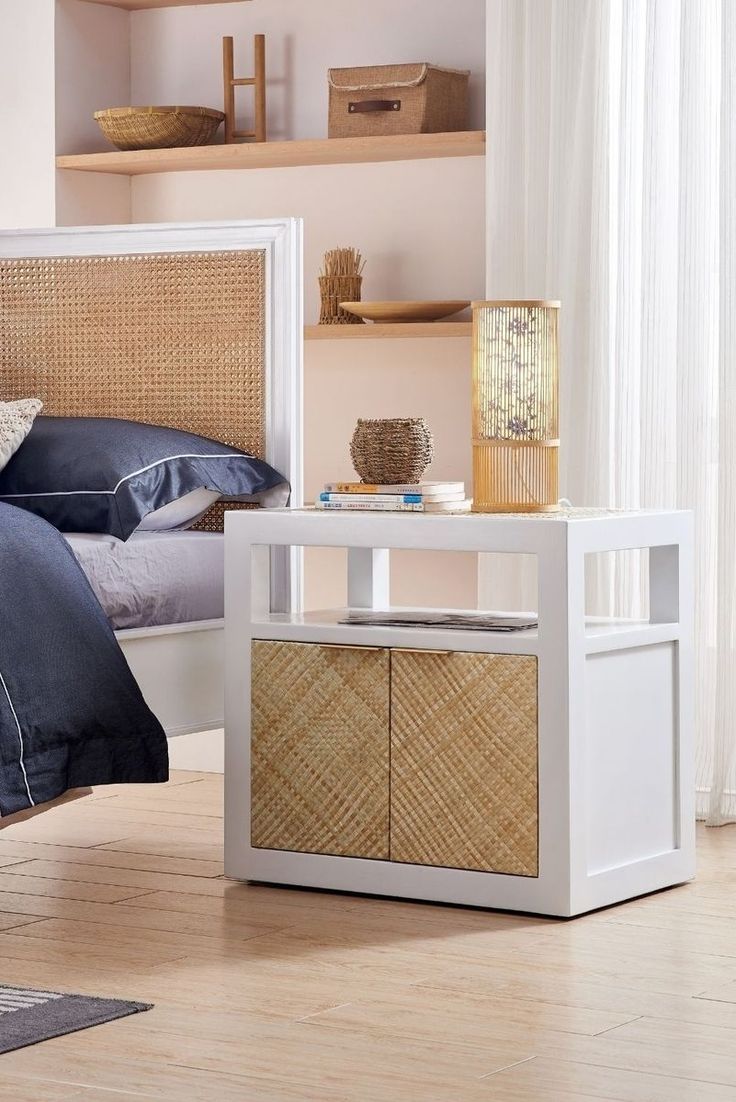 a bedroom with white furniture and wood floors