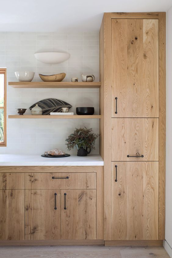 the kitchen is clean and ready for us to use it's natural wood cabinetry